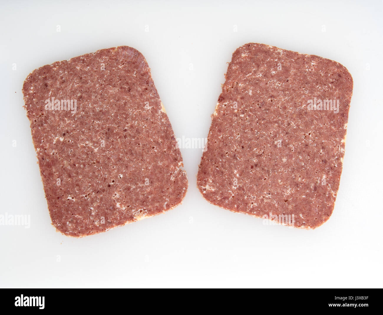 Two slices of Corned Beef on a white background Stock Photo Alamy