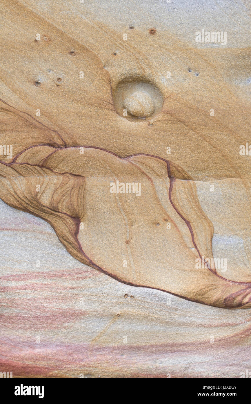 An abstract shape in a sandstone cliff that resembles a seated figure. Stock Photo