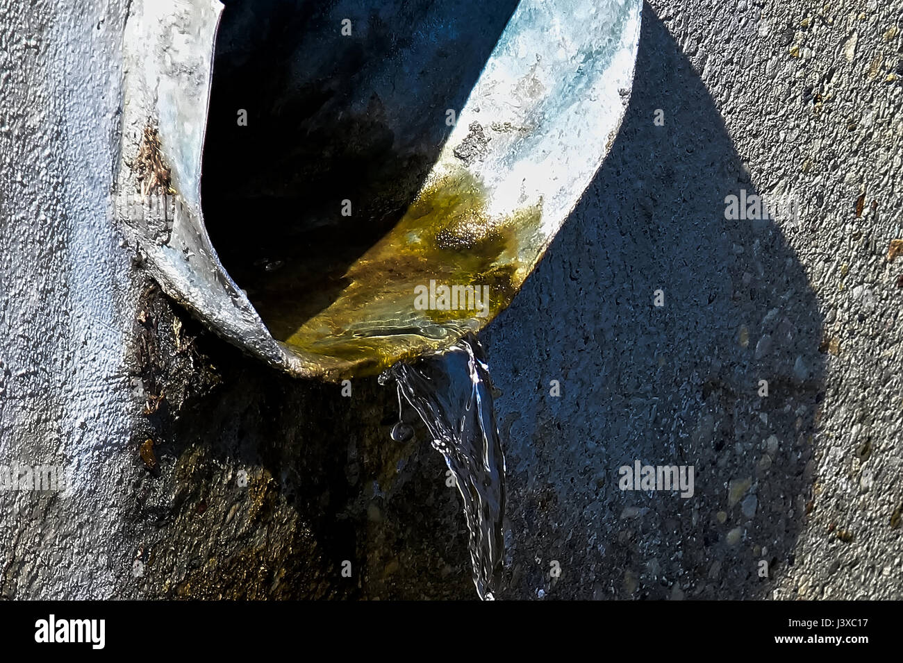 Closeup of water flowing from a pipe. Stock Photo