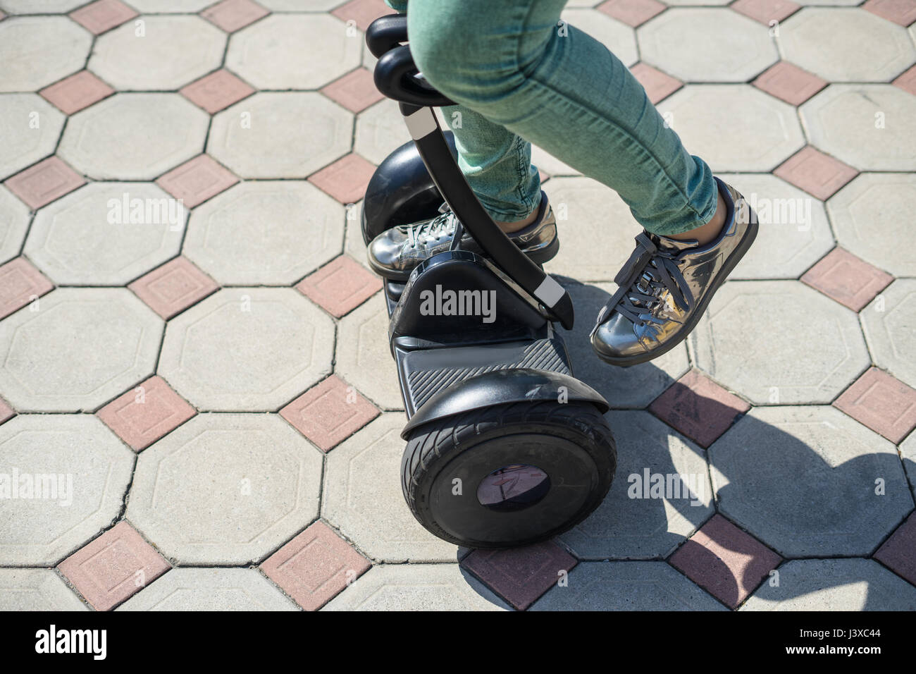 woman legs start riding gyroscooter or hoverboard Stock Photo