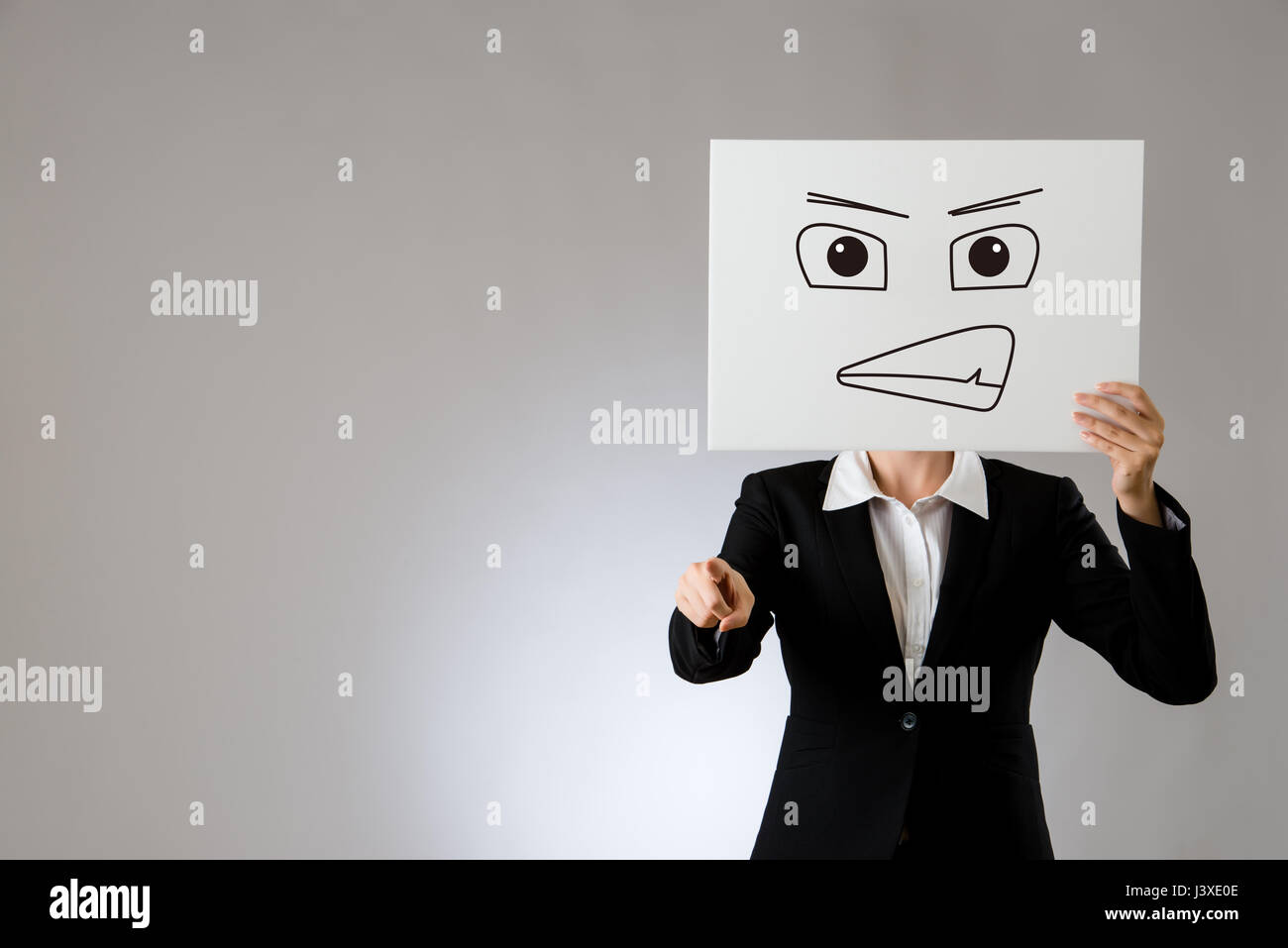 mad office lady feel unhappy face draw on blank poster with criticize pointing finger. isolated on gray background. business office company concept. Stock Photo