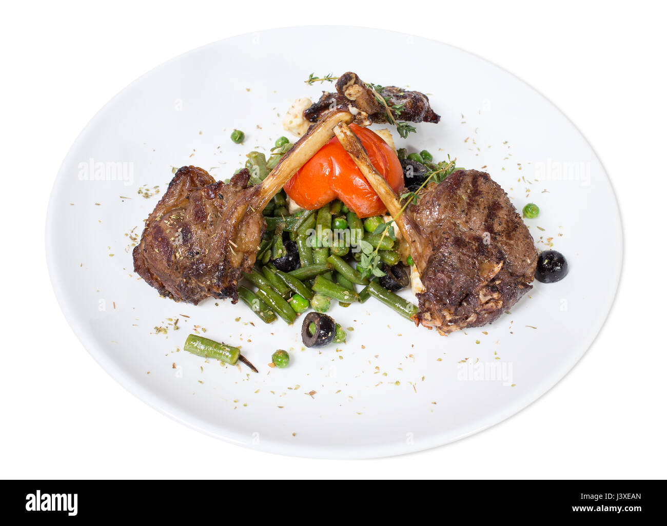 Grilled beef ribs with french beans and tomatoes. Isolated on a white background. Stock Photo