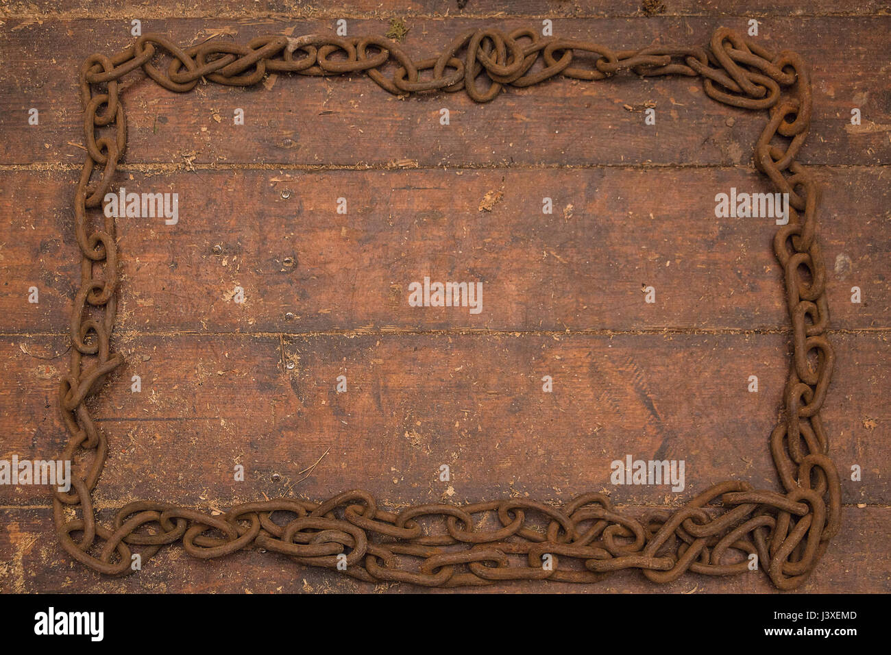 Grunge retro wooden background, old rusty iron chain frame. Stock Photo