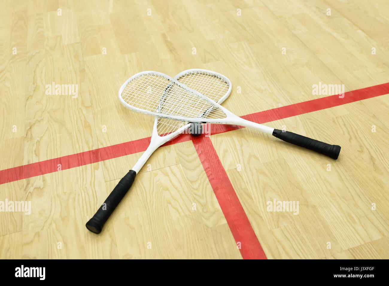 squash rackets and ball on the court near red line. Racquetball