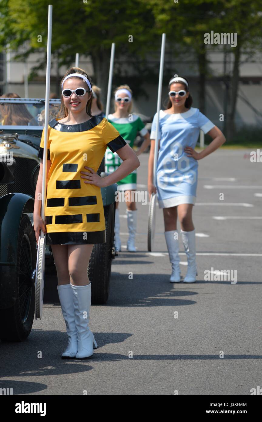 Grid girls in 1960's fashion at the annual Benjafields Racing Club event held at the Goodwood Motor Circuit in West Sussex, England. Stock Photo