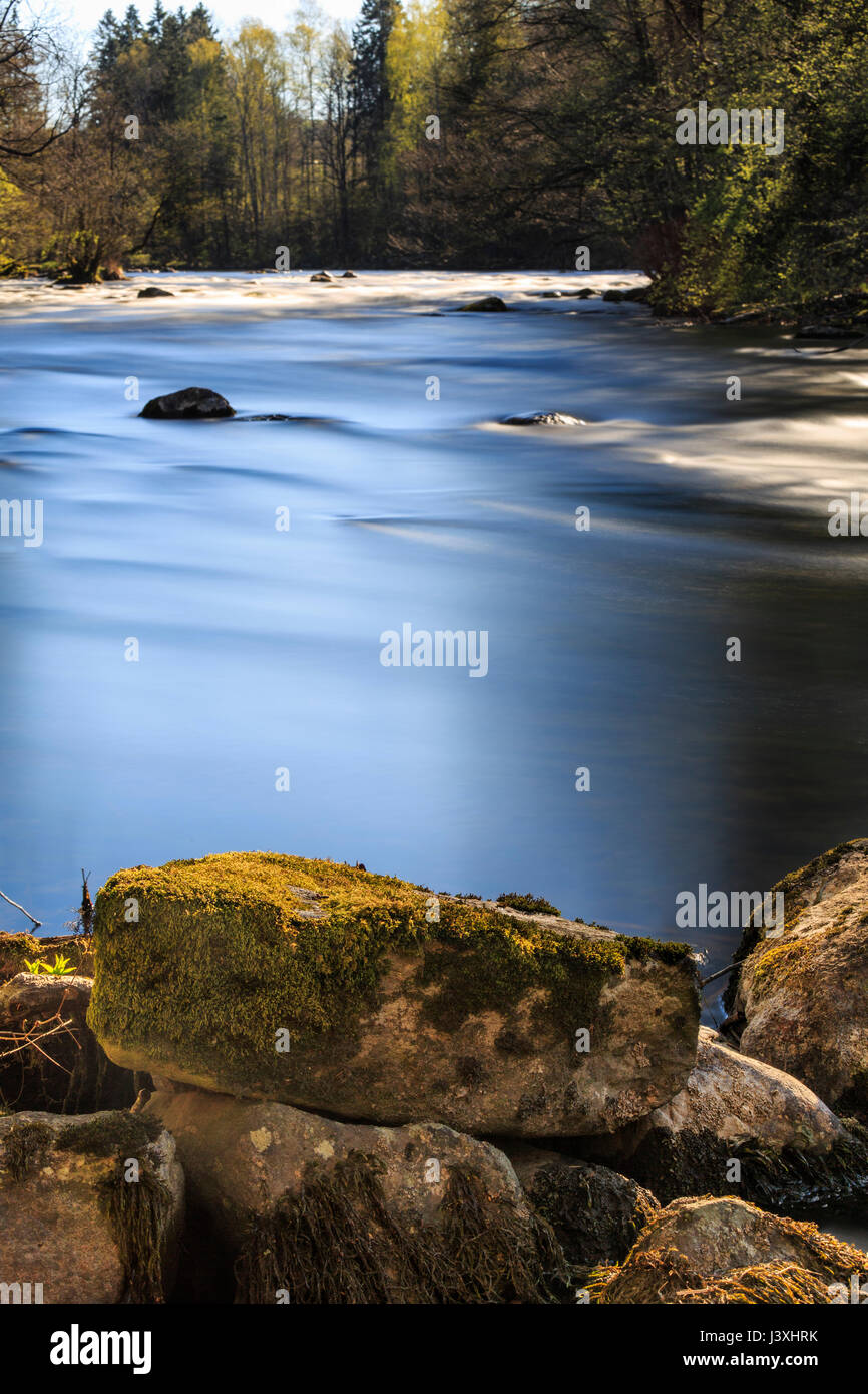 Long exposure of Swedish nature landscape showing water flowing over rocks by a bend in river Säveån, Floda, Sweden  Model Release: No.  Property Release: No. Stock Photo