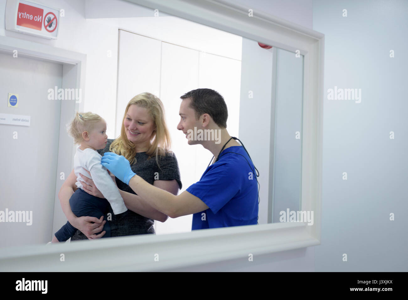 Dentist checking child's teeth in dental surgery Stock Photo