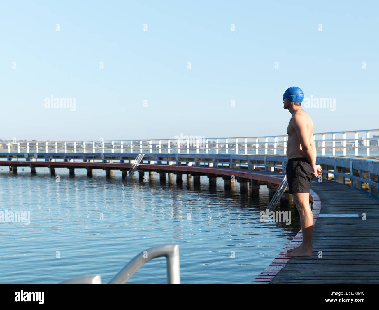 Swimmer contemplating on boardwalk, Eastern Beach, Geelong, Victoria, Australia Stock Photo