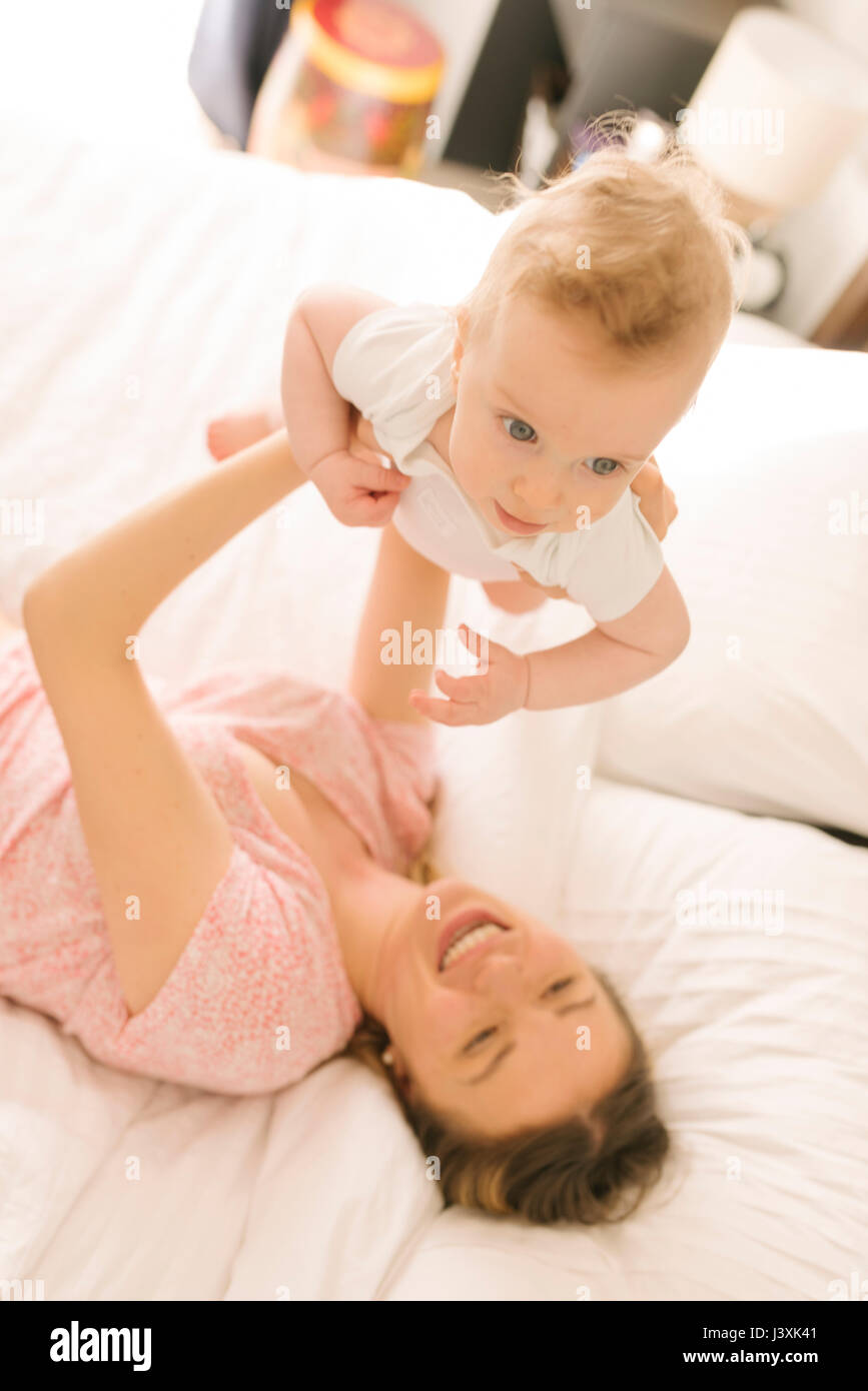 Mother and baby bonding on bed Stock Photo