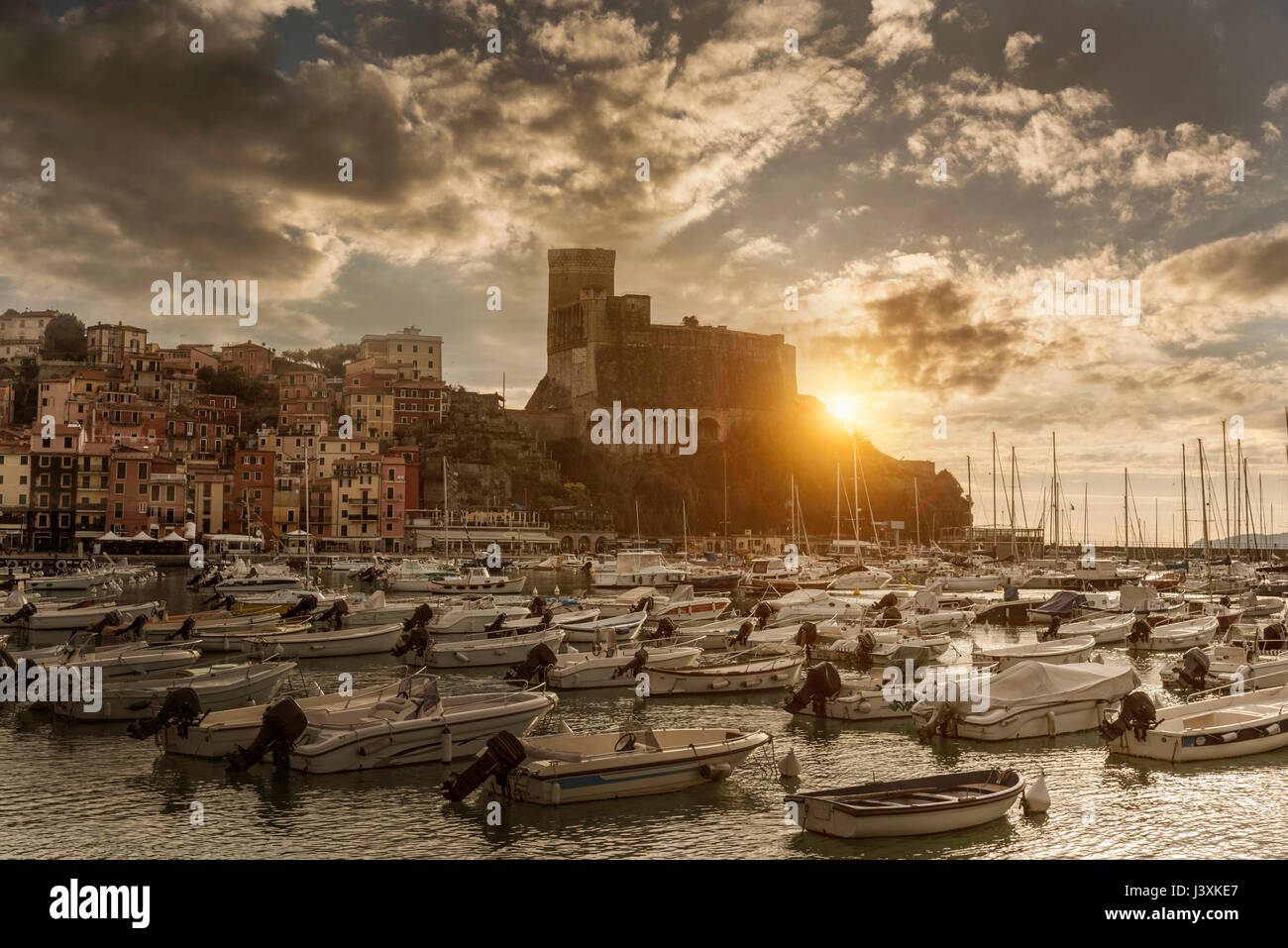 View of harbour yachts and castle at sunset, Lerici, Liguria, Italy Stock Photo