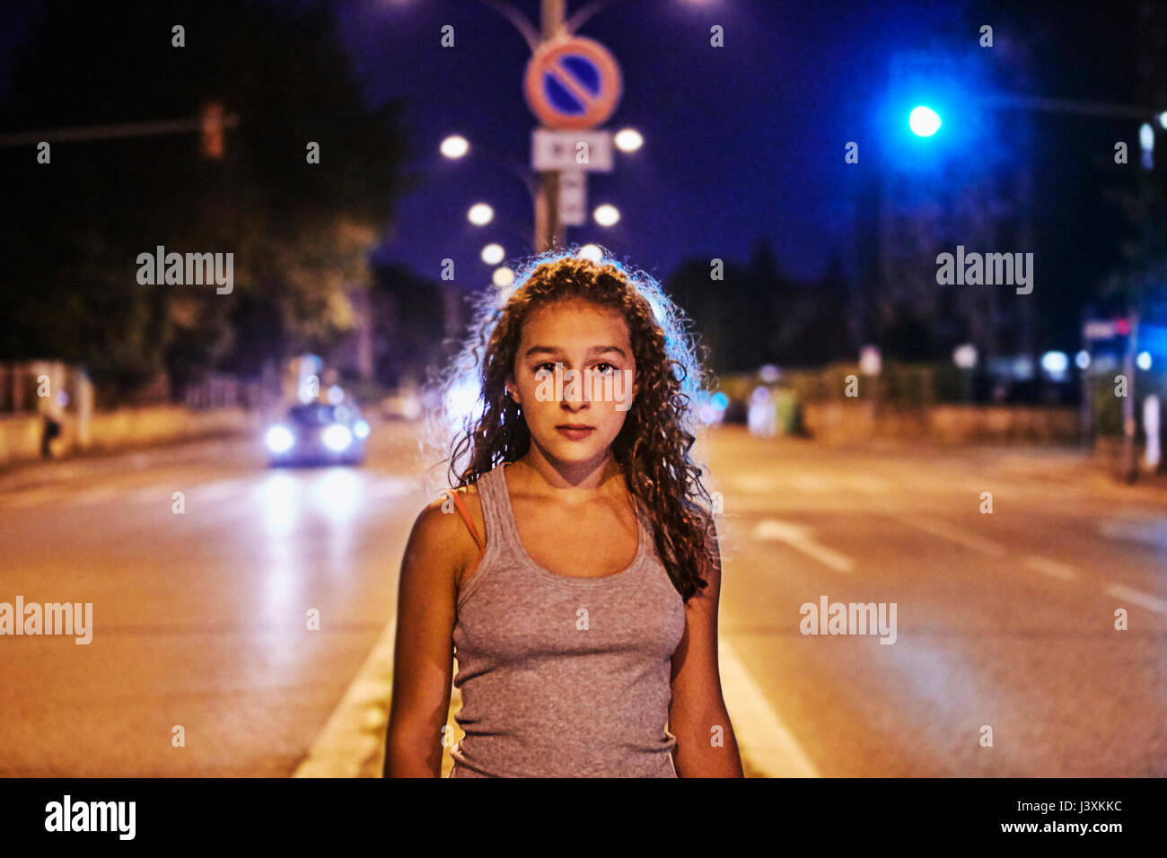 Portrait of teenage girl in the middle of the road looking at camera Stock Photo