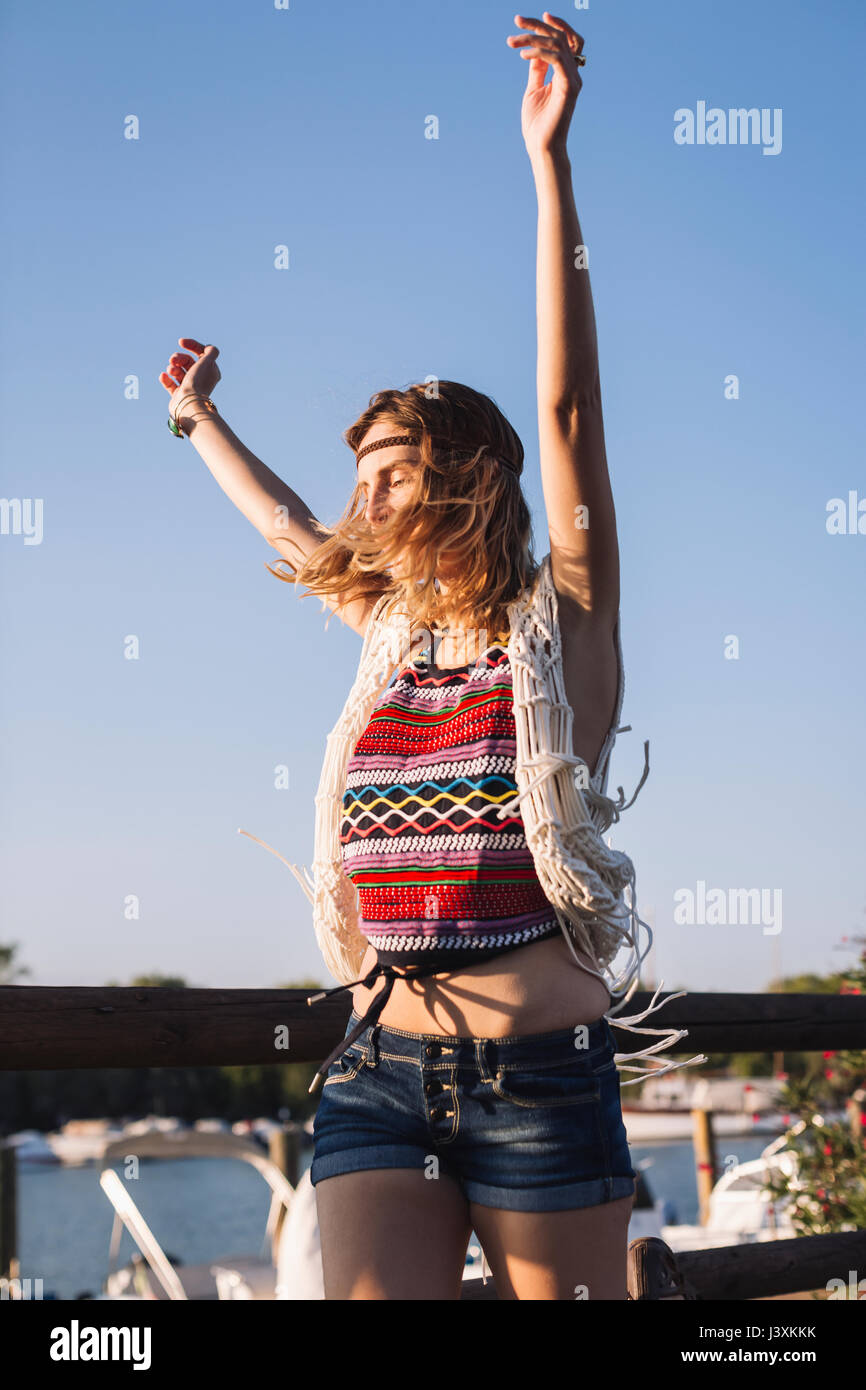 Woman with arms raised in jubilation Stock Photo