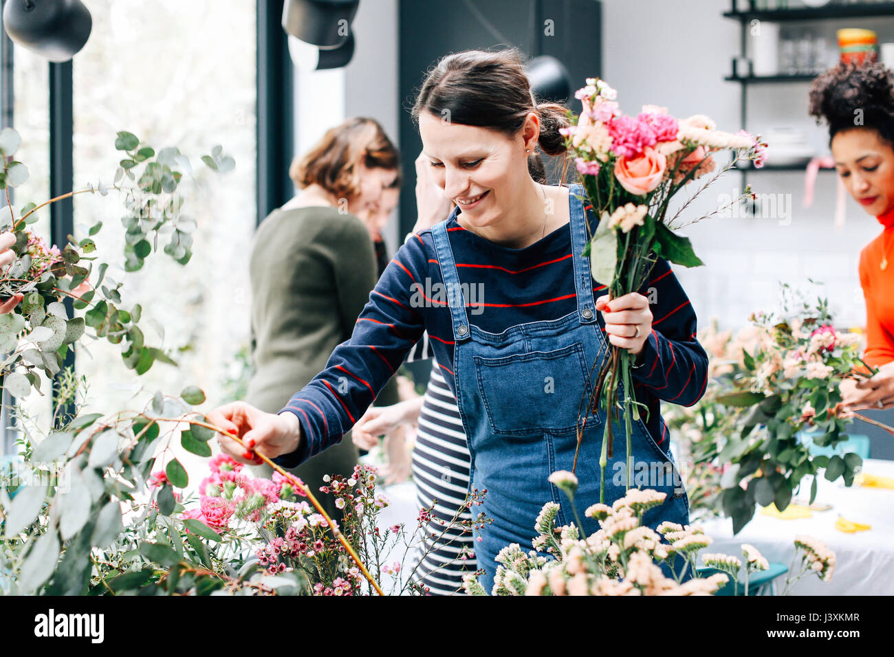 Florist student selecting cut flowers at flower arranging