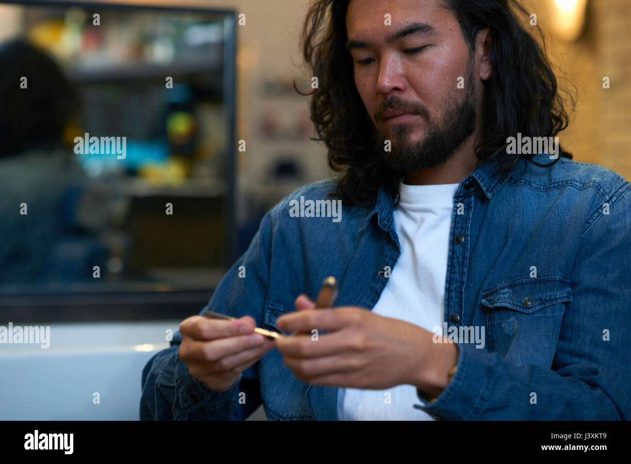 Barber opening straight razor in barber shop Stock Photo Alamy