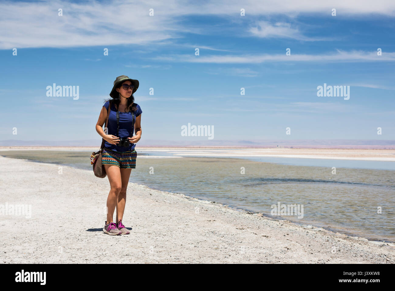 Woman by lake, San Pedro de Atacama, Chile Stock Photo
