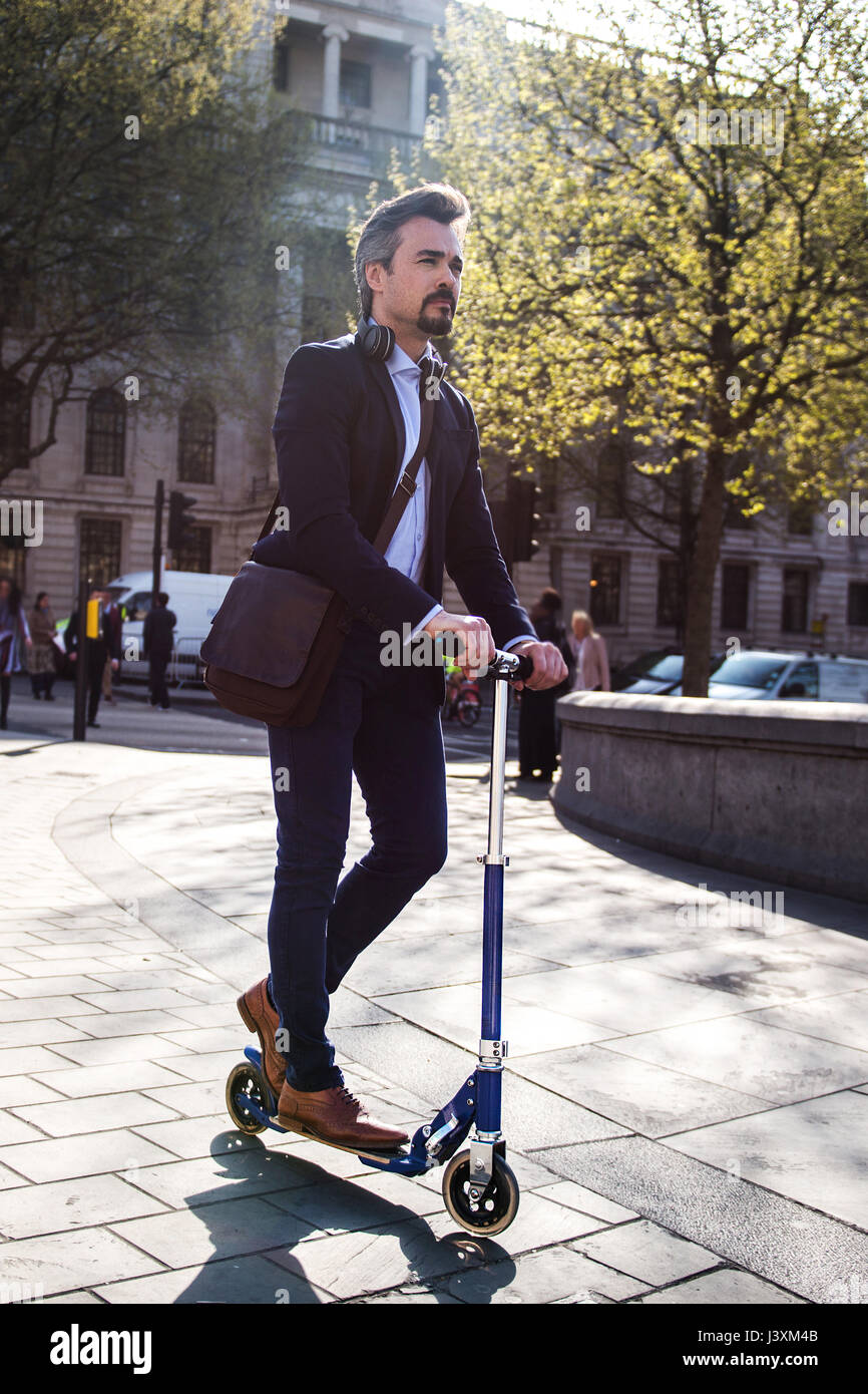Businessman on scooter, Trafalgar Square, London, UK Stock Photo Alamy