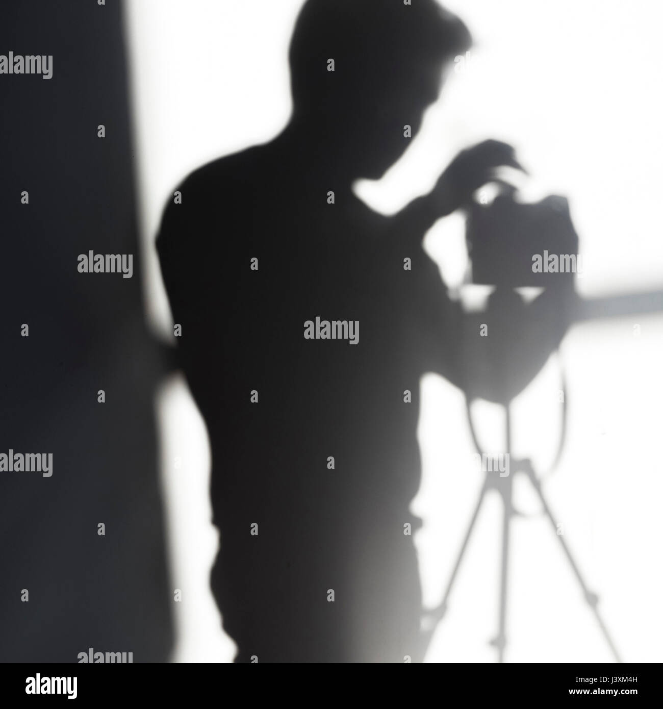 Shadow of photographer with camera on tripod Stock Photo Alamy