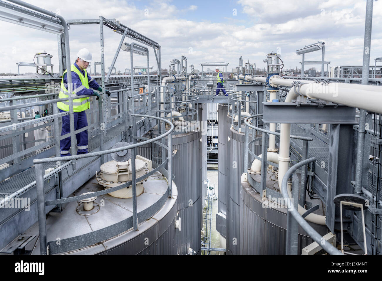 Workers on top of process plant in oil blending factory Stock Photo