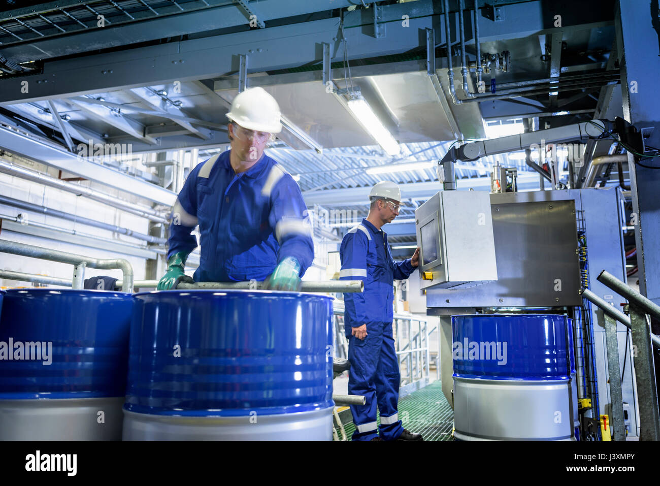 Workers with process machinery in oil blending factory Stock Photo Alamy