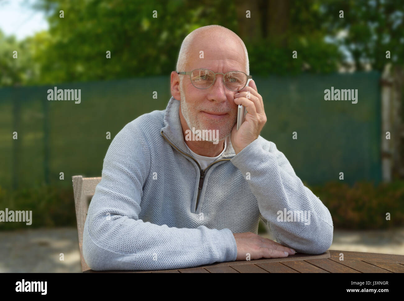 a senior man using the mobile phone outside Stock Photo - Alamy