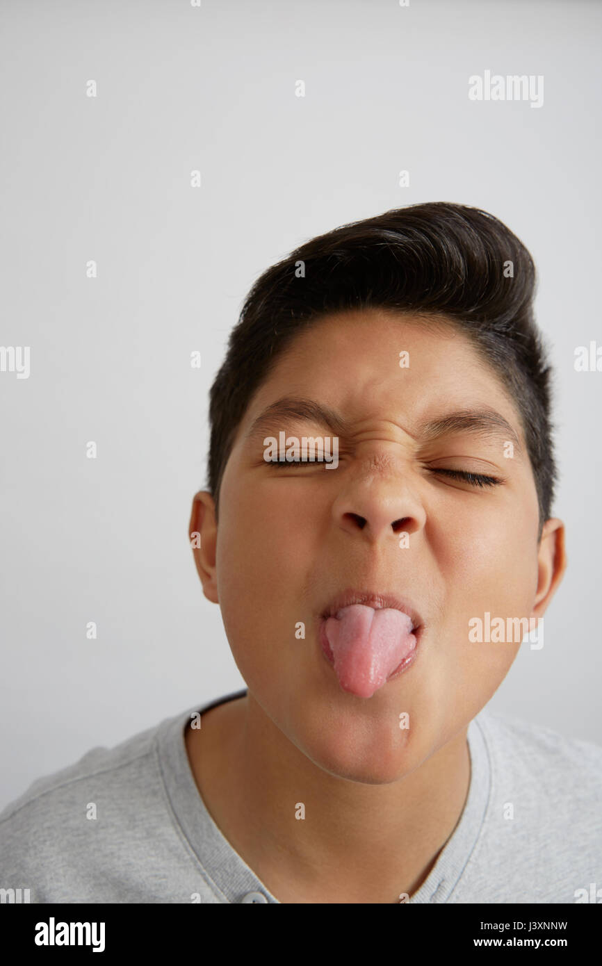 Portrait of boy sticking out tongue Stock Photo