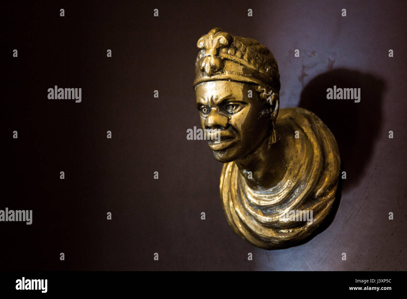 Door knob in the shape of the face of an African man. Venice, Italy. Stock Photo