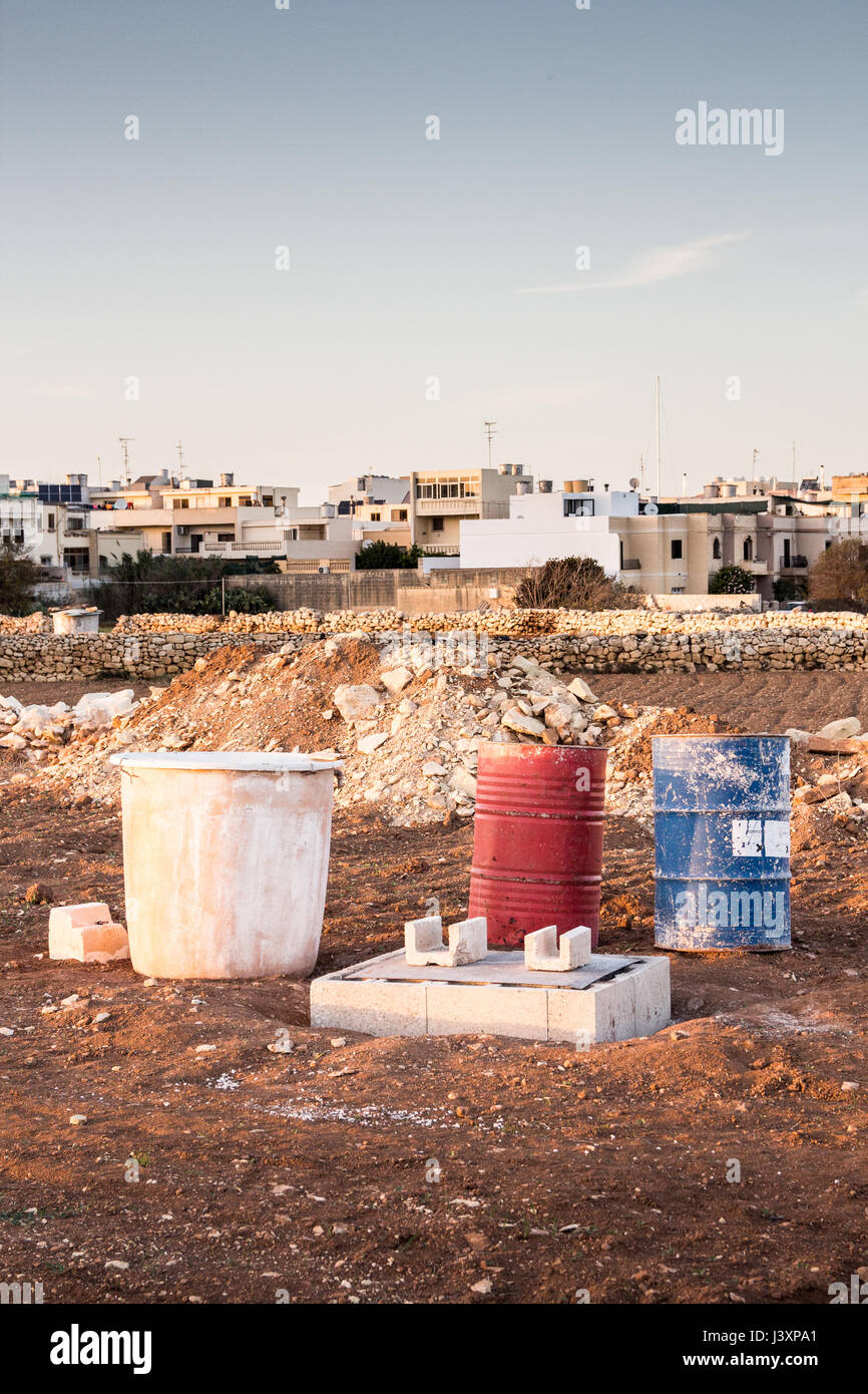 Construction material and activities in a field on the outskirts of Attard and Mosta, Malta. Stock Photo