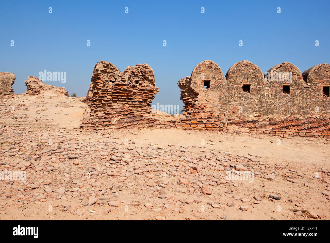 fancy walls and brickwork currently being restored at bhatner fort in hanumangarh rajasthan india under a clear blue sky in springtime Stock Photo