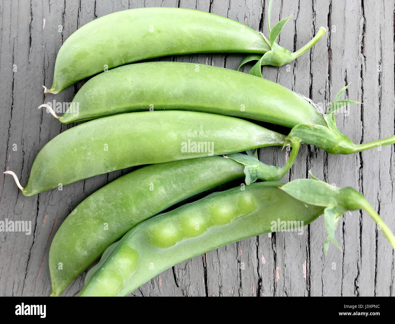 Group of fresh peas in the pod from the garden. Stock Photo