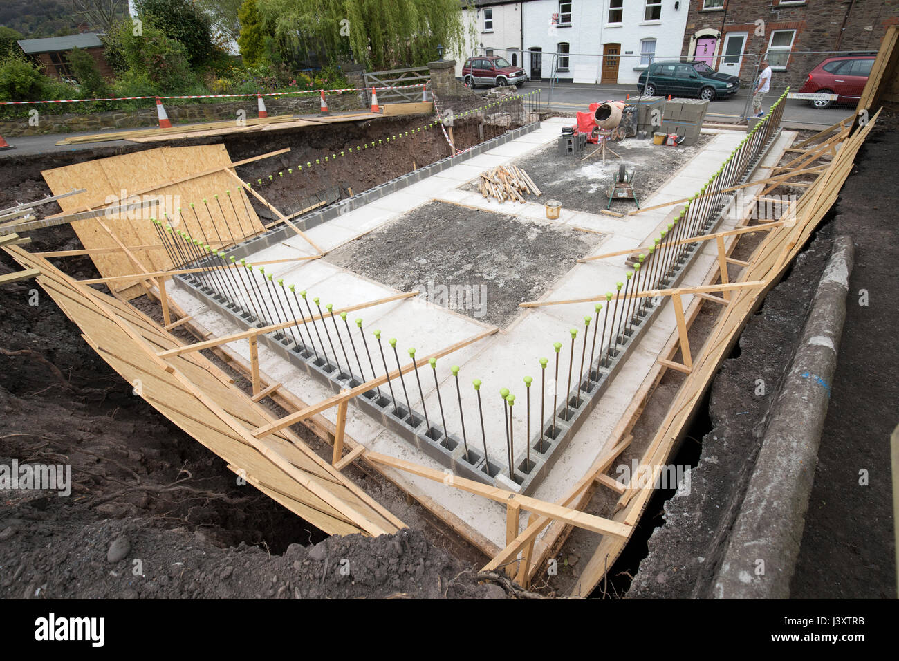 Concrete footings prepared for new build house infill plot dug into bank, Abergavenny, Wales, UK Stock Photo