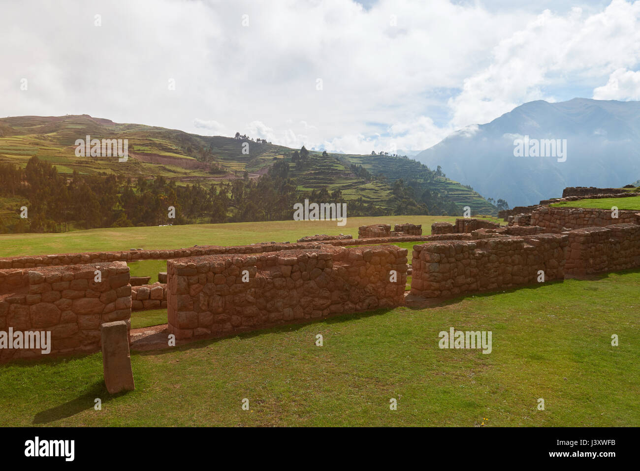 Ruins in Peruvian landscape on sunny light day. Stone wall in sacred valley Stock Photo
