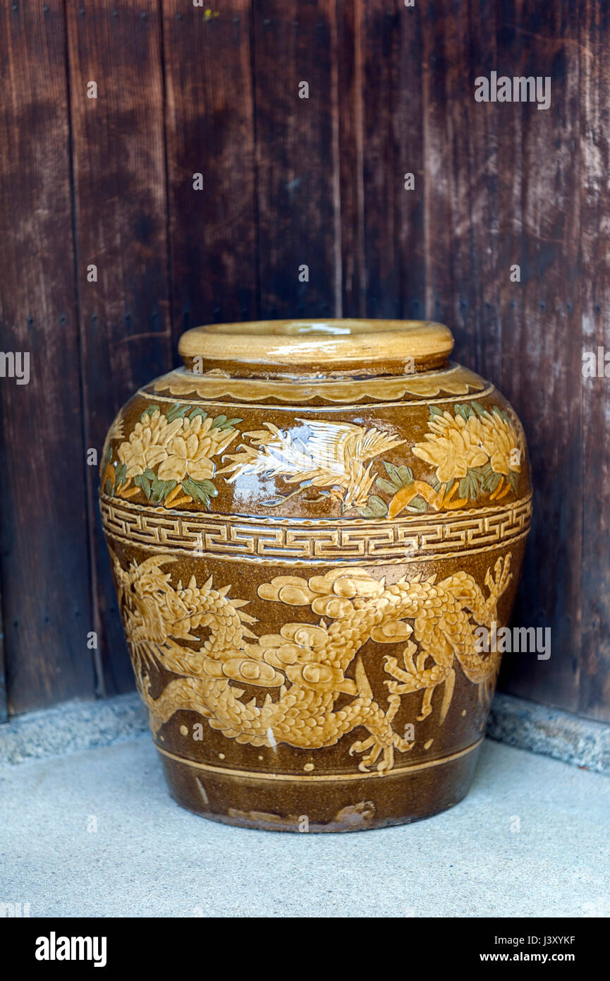 Old Japanese glazed earthenware or ceramic jar with dragon pattern