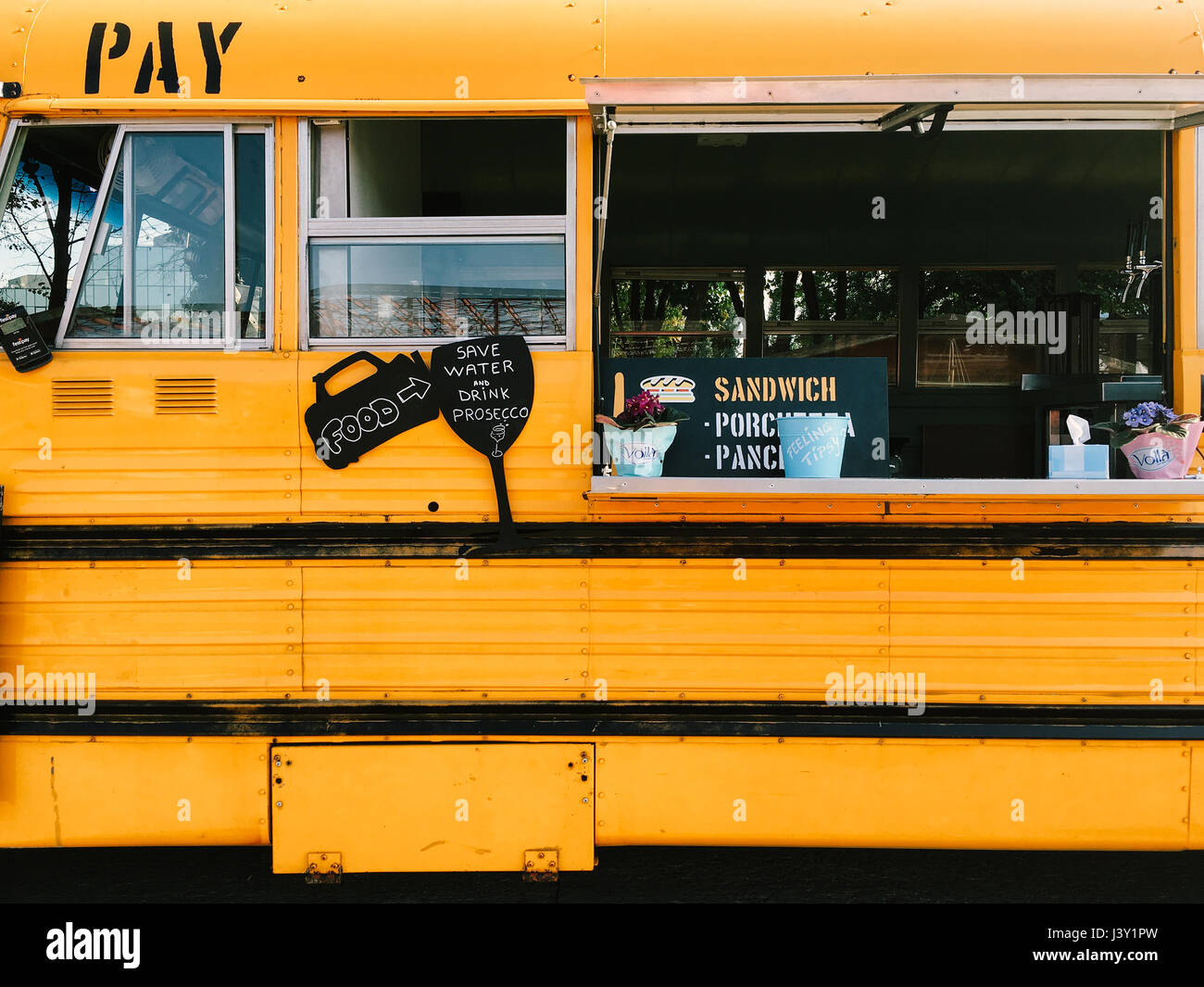 BUCHAREST, ROMANIA - SEPTEMBER 09, 2016: Vendors Selling Street Food From American School Bus. Stock Photo