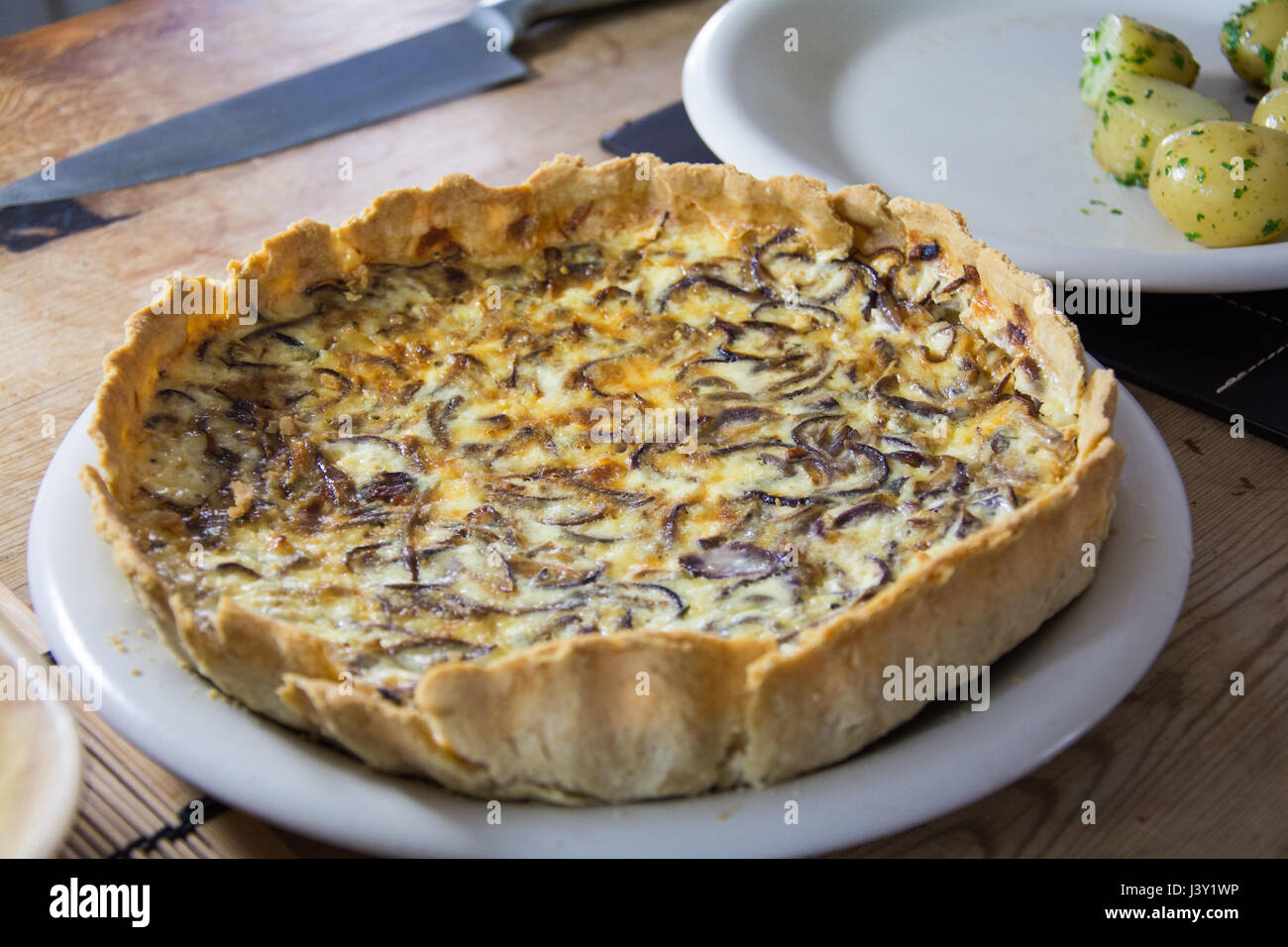 A homemade caramelized red onion flan. Rustic vegetarian food. Stock Photo