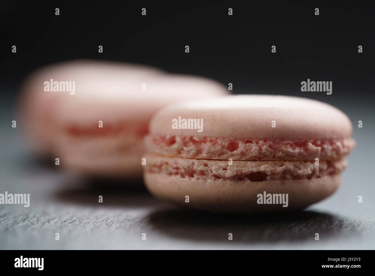 light pink macarons on slate background Stock Photo