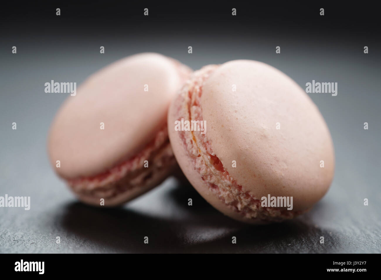 light pink macarons on slate background Stock Photo