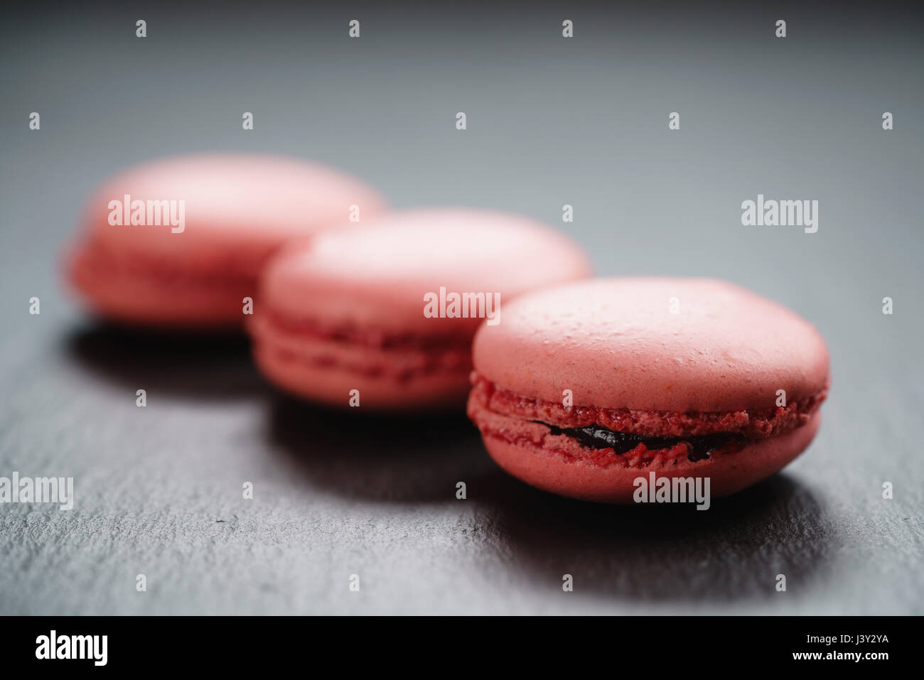 bright pink macarons on slate background Stock Photo