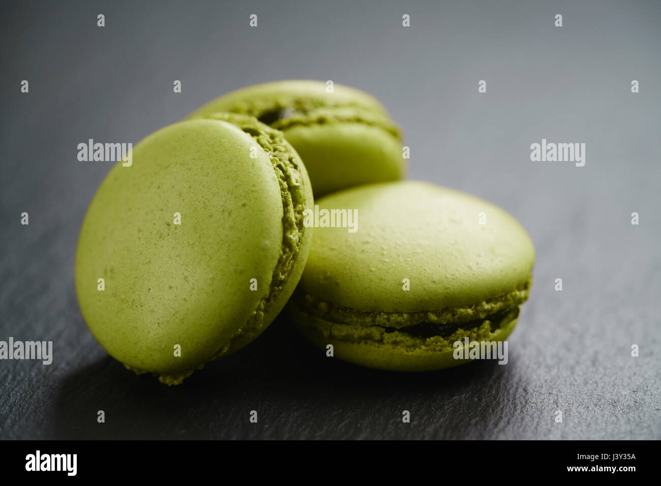 bright green macarons on slate background Stock Photo