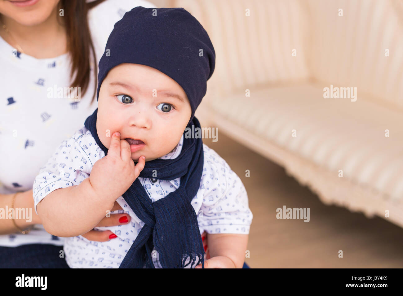 Portrait of cute baby boy wearing blue hat Stock Photo - Alamy