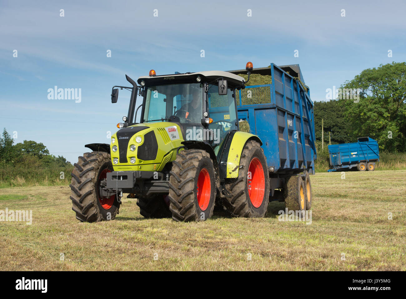 Carting grass in a forage wagon for silage using a Claas tractor, Longridge, Preston, Lancashire.UK Stock Photo
