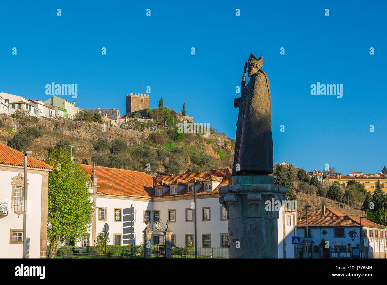 Lamego Portugal center, statue of Bishop Dom Miguel in the centre of Lamego with the medieval Castelo visible on the town's skyline, Portugal, Europe Stock Photo