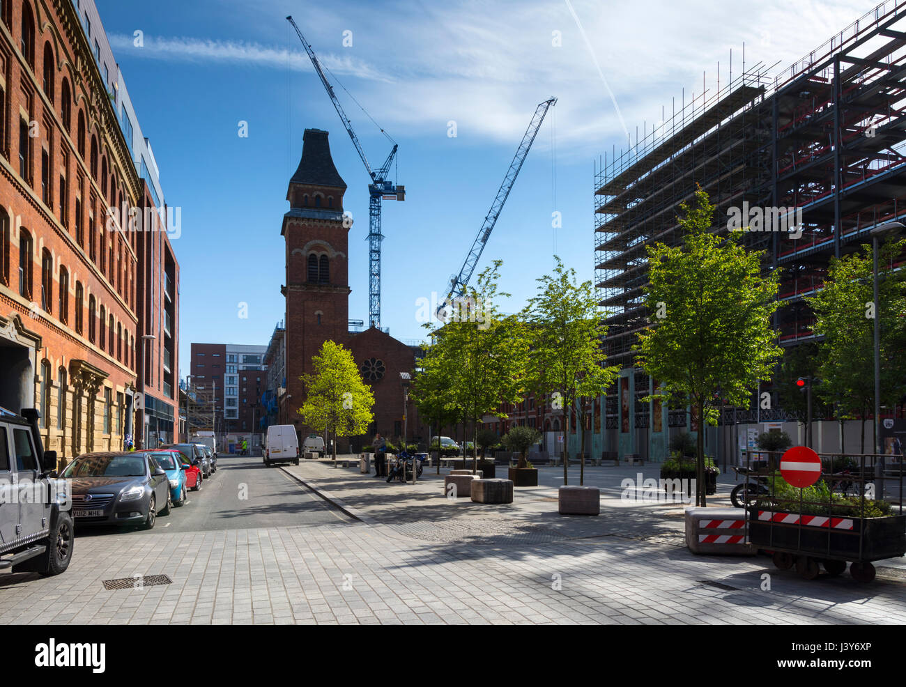 The former church of St. Peter and the 'One Cutting Room Square' construction site, Cutting Room Square, Ancoats, Manchester, England, UK Stock Photo