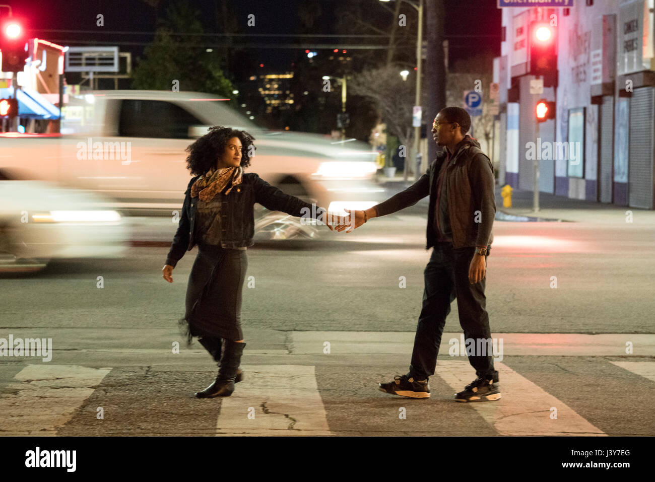 Couple holding hands on pedestrian crossing, Los Angeles, California, USA Stock Photo