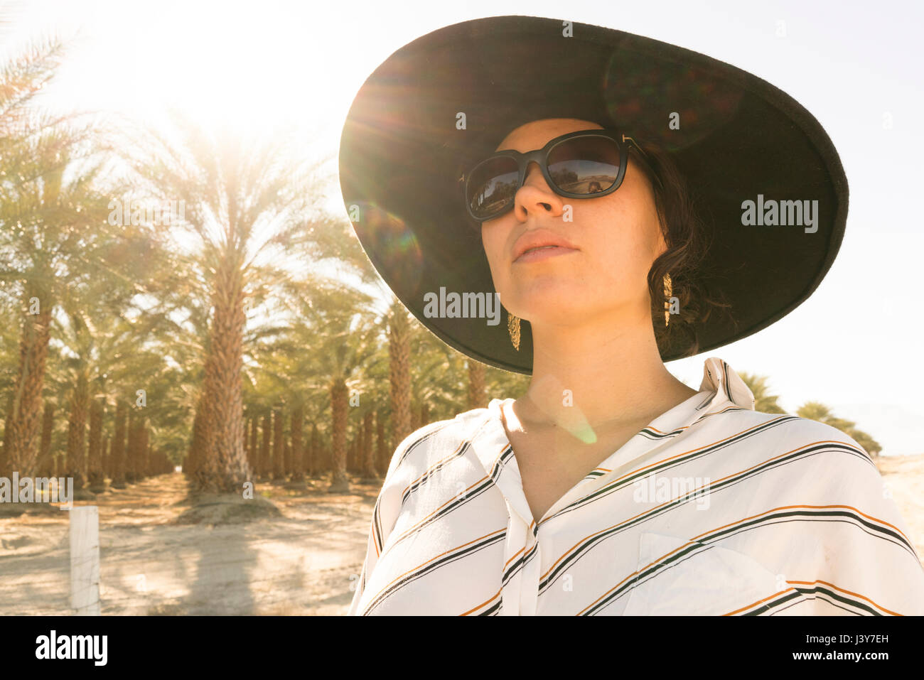 Portrait of woman wearing sunglasses and sunhat looking away, Palm Springs, California, USA Stock Photo