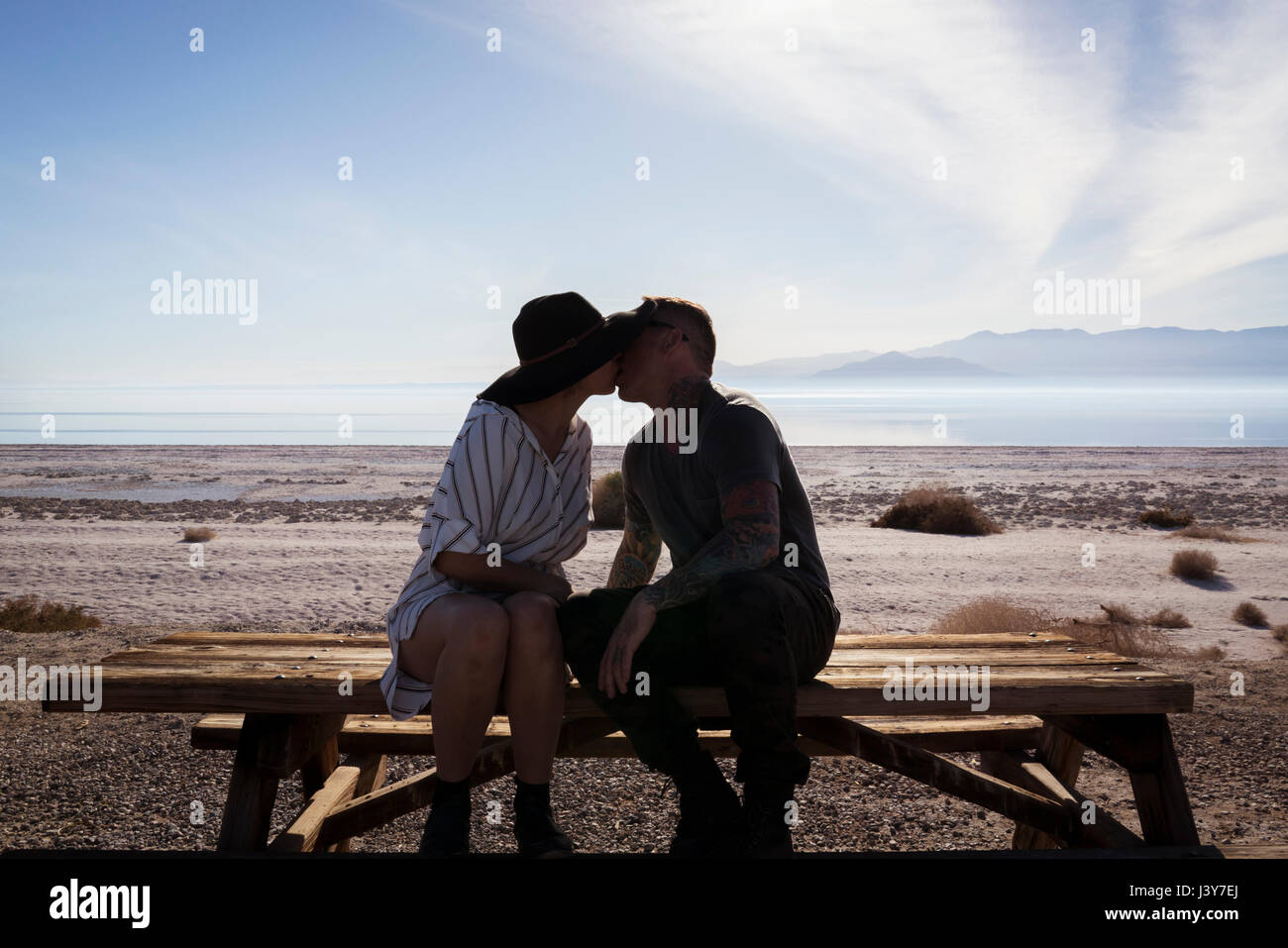 Couple on bench kissing in hi-res stock photography and images - Alamy