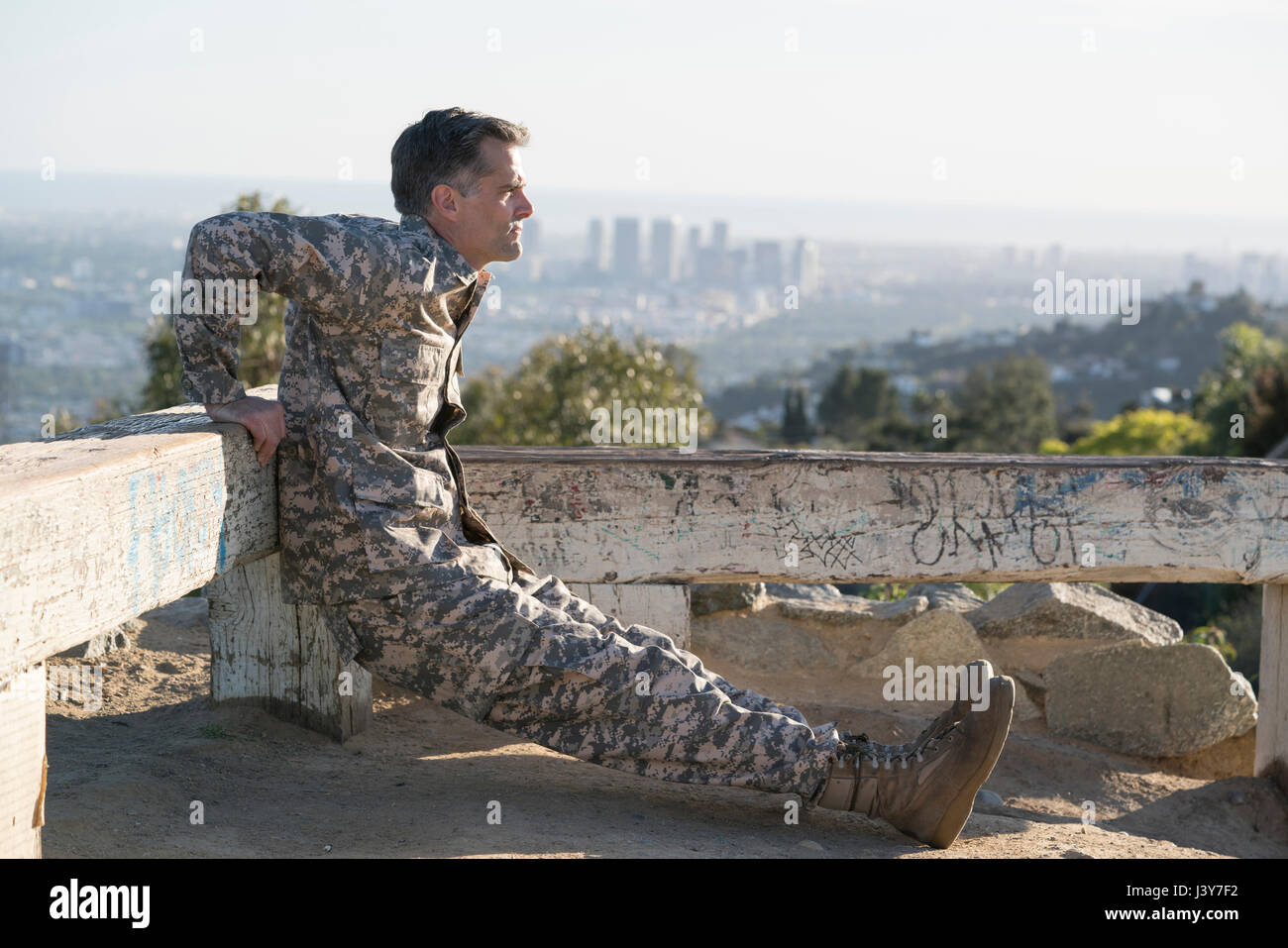 Soldier wearing combat clothing doing reverse push up, Runyon Canyon, Los Angeles, California, USA Stock Photo