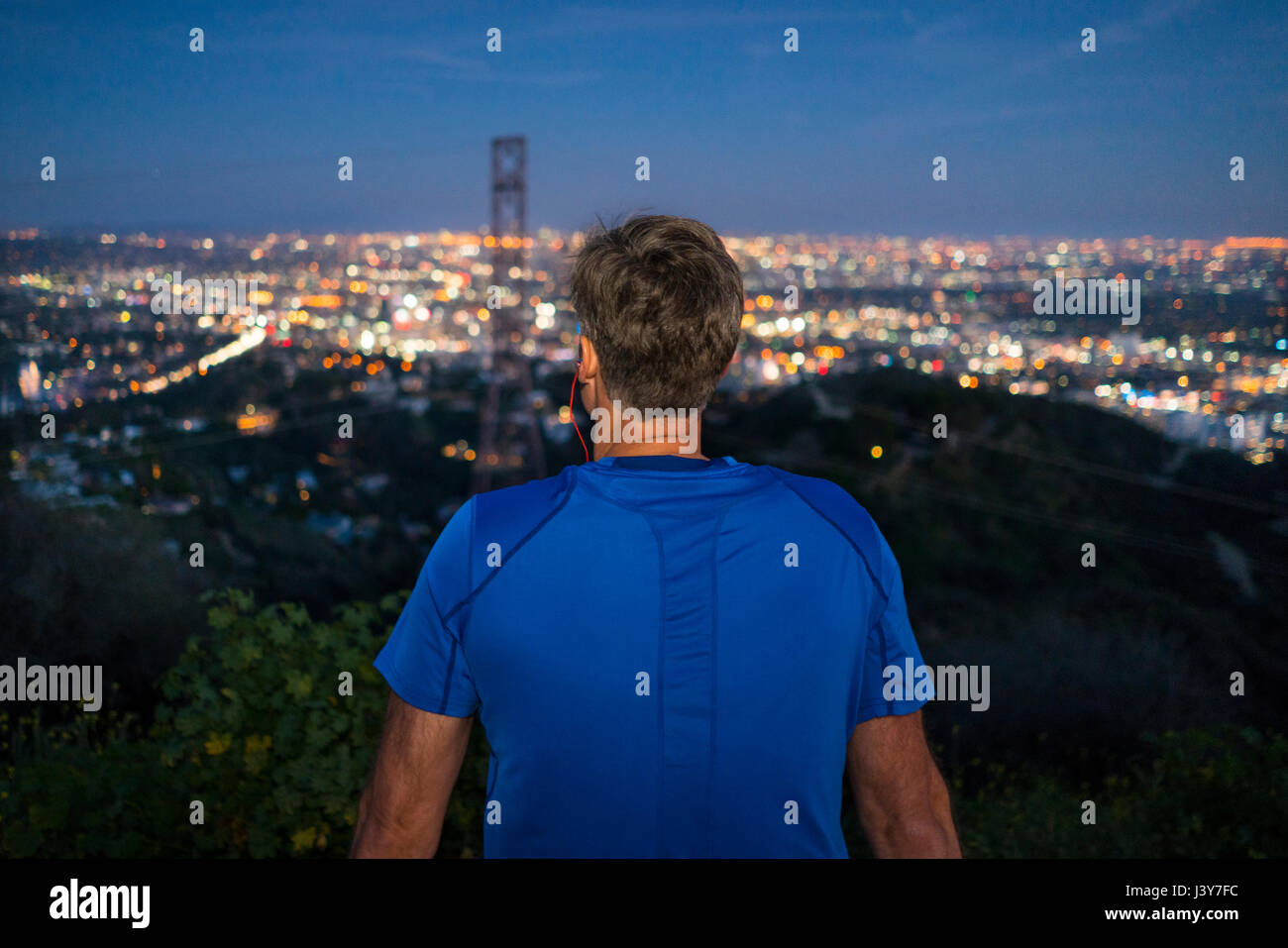 Rear view of jogger looking away at view, Runyon Canyon, Los Angeles, California, USA Stock Photo