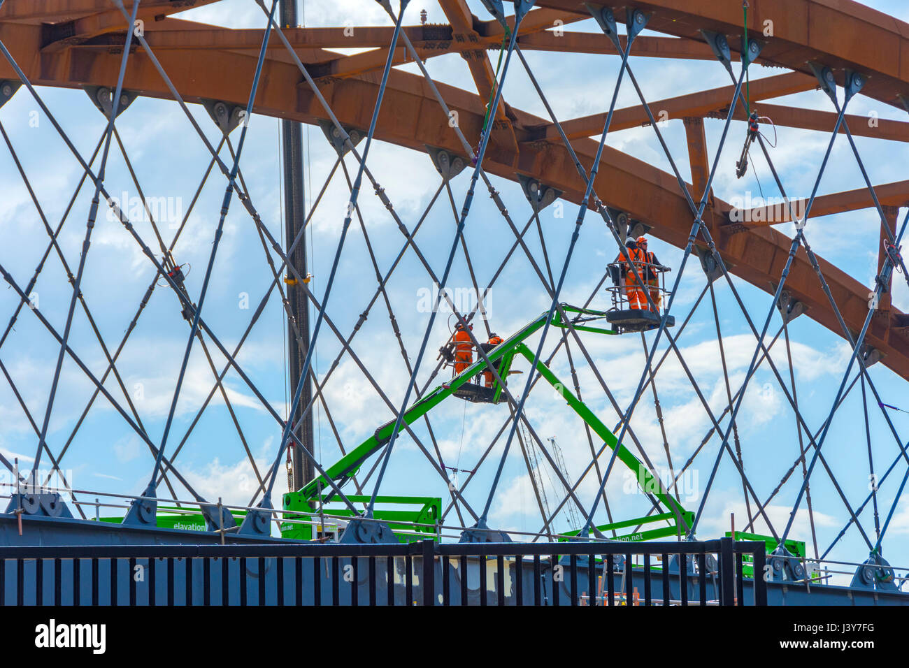 Workmen on access platforms on the new rail bridge under construction over the river Irwell, Ordsall Chord rail link project, Salford, Manchester, UK Stock Photo