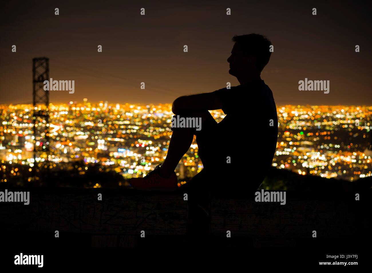 Silhouette of jogger on bench looking away at view, Runyon Canyon, Los Angeles, California, USA Stock Photo