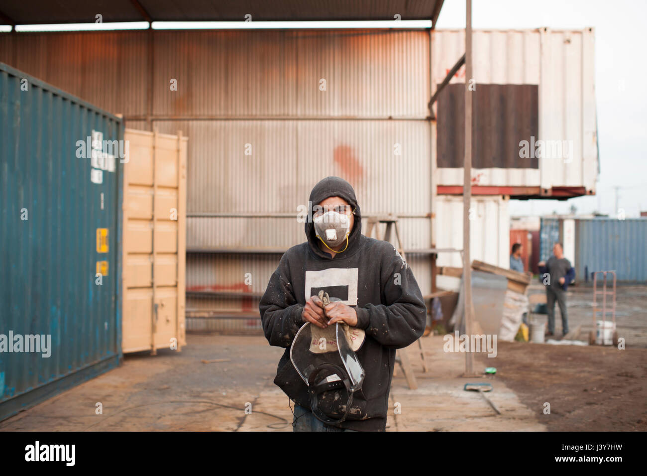 Portrait of man on construction site wearing protective face mask Stock Photo